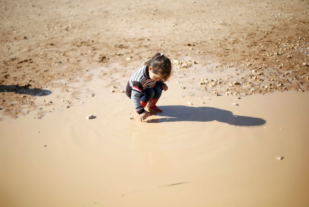 A Syrian refugee child plays at Al Zaatari refugee camp in Jordan near the border with Syria, December 3, 2016. Photo by Muhammad Hamed/Reuters