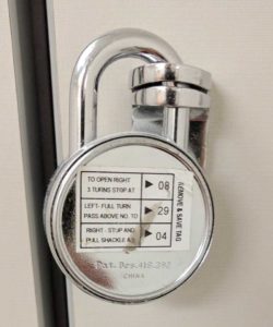 Combination lock with security code sticker still on the back