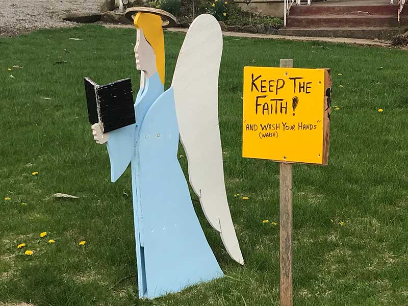 Angle and Keep the Faith and Wash Your Hands sign. 
