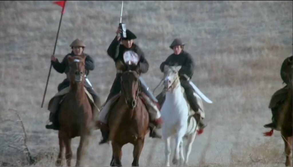 1975 Kung Fu TV show troops riding horses chasing down Grasshopper with what appears to be a walkie talkie in the leads hand.
