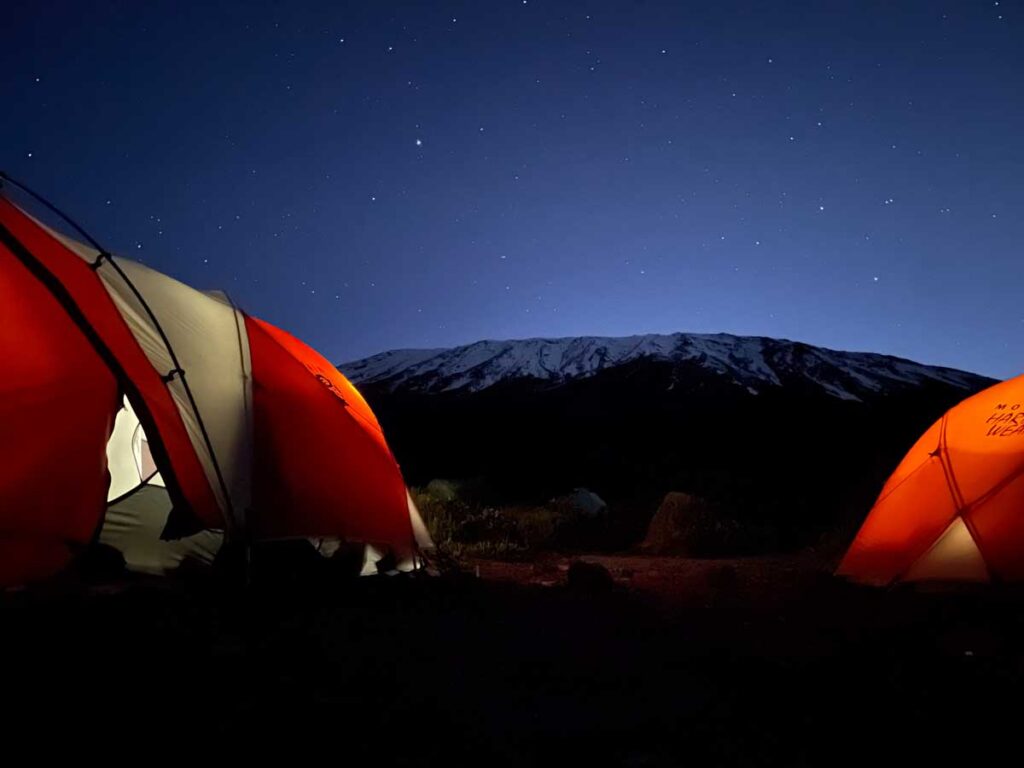 The first photo is facing south and features Kibo Peak: the tallest of the three Kili summits. The most common shots of Kili are from the Kenya side: giving the iconic broad peak that most associate with images of the mountain. 